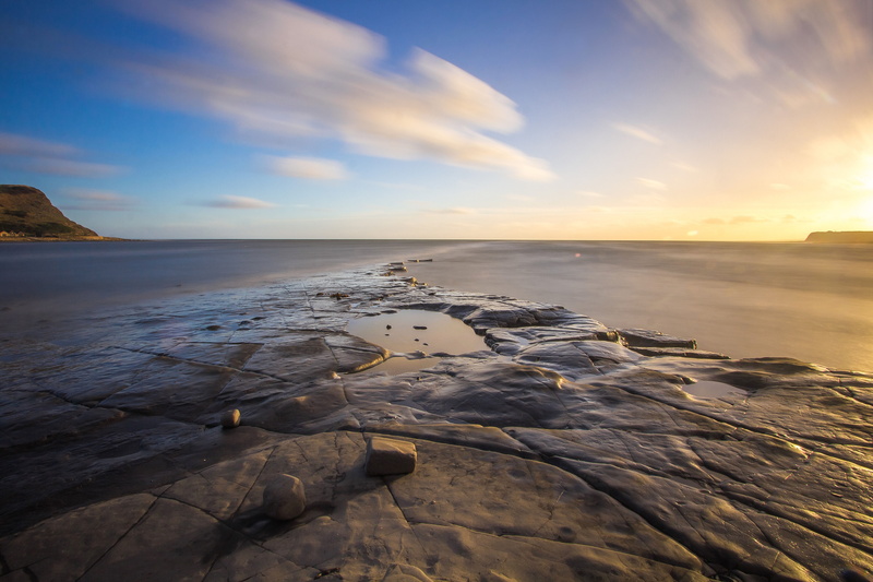 coast, person, land, beauty in nature, rock, sun, cloud - sky, showing, shore, sand, sea, no people, sky, bay, sunrise, landscape, water, horizon over water