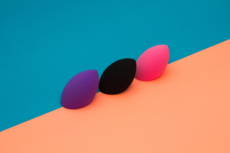 colored background, still life, high angle view, science, paper, makeup, colourful, blending sponge, colorful, red, studio shot, indoors, group of objects