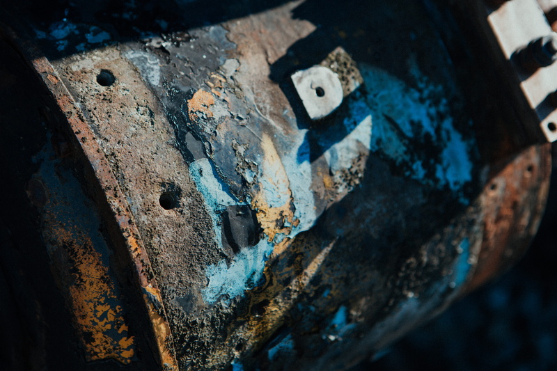 sphere, blue, metal, textured, cassette, weathered, furniture, hole, outdoors, focus on foreground, train, close-up, building, palette, no people, abandoned