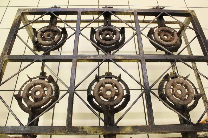 building, kitchen, art and craft, cook, metal, ornate, gas stove, day, security, indoors, built structure, no people, safety, wrought iron, focus on foreground