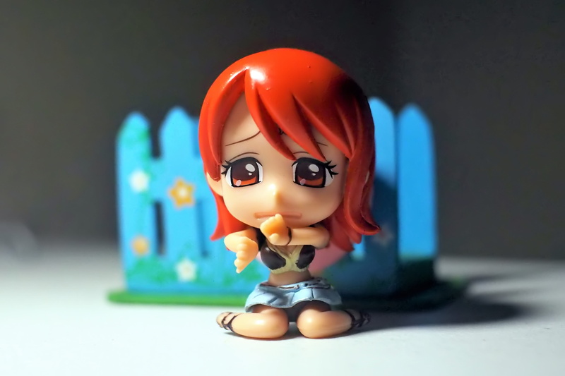 sculpture, single object, figurine, tv, studio shot, nami, toy, close-up, male likeness, adorable, small, female, series, table, young, no people, human representation