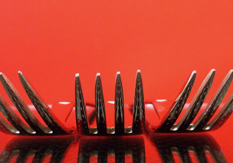 high angle view, metal, steel, gastronomy, kitchen utensil, food and drink, table cover, red, metal fork, indoors, tine, copy space, studio shot, red background