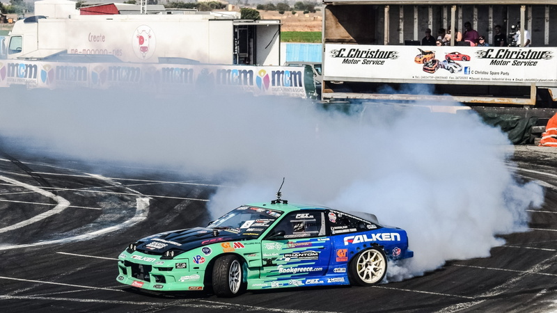 smoke, drift, day, fast, motorsport, communication, winning, mode of transportation, championship, built structure, racing, architecture, outdoors, road
