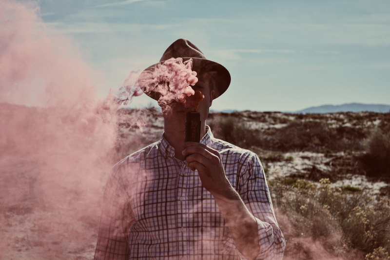 field, land, 4K, device, front view, holding, man, blue sky, pink, mid adult men, standing, hat, check shirt, portrait, united states, one person, pose