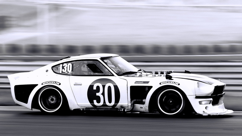 selective focus, outdoors, speed, motor racing track, sports race, car, Datsun, no people, motion, security, land vehicle, day, competition, protection