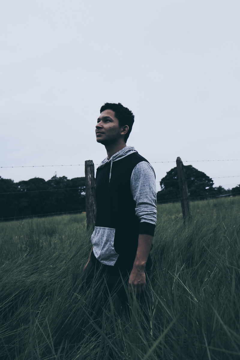 contemplation, model, real people, standing, panama, 5K, outdoors, young adult, sky, hoodie, community, land, lifestyles, one person, hope, casual clothing