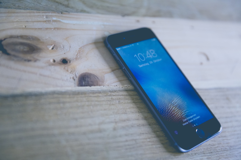 iphone 6, western script, mobile phone, desk, touchscreen, indoors, time, touch, technology, telephone, smart phone, designer, table, space, wooden surface