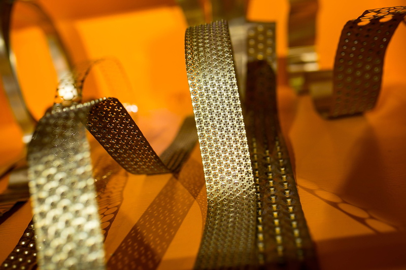 illuminated, art, selective focus, decoration, indoors, day, gift, bended, 2K, installation, exhibition, shape, jewelry, retail, shiny, ribbon, close-up