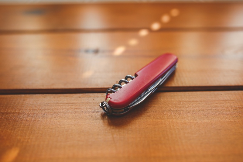 arts culture and entertainment, desk, red, knife, wooden, 5K, close-up, connection, wood grain, surface, copy space, musical instrument, wood - material