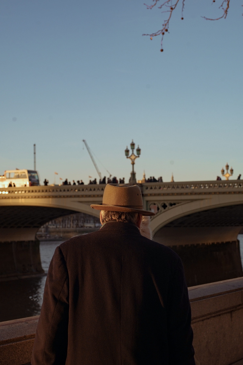 real people, fedora, standing, clear sky, city, electrical device, 5K, hat, walk, transportation, sunset, architecture, united kingdom, leisure activity