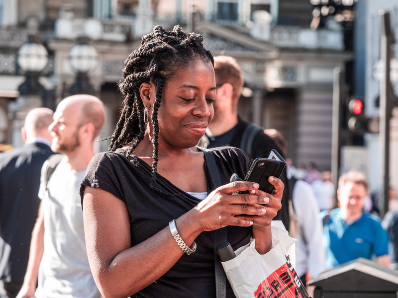 person, people, women, fashion, app, united kingdom, holding, book, using phone, london, pedestrian, portable information device, urban, men, phone, adult