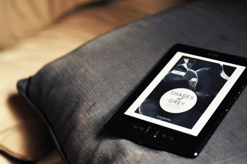 book, selective focus, non-western script, indoors, technology, dvd, screen, still life, no people, pillow, touch screen, jewelry, shades, grey, text, 50 shades of grey