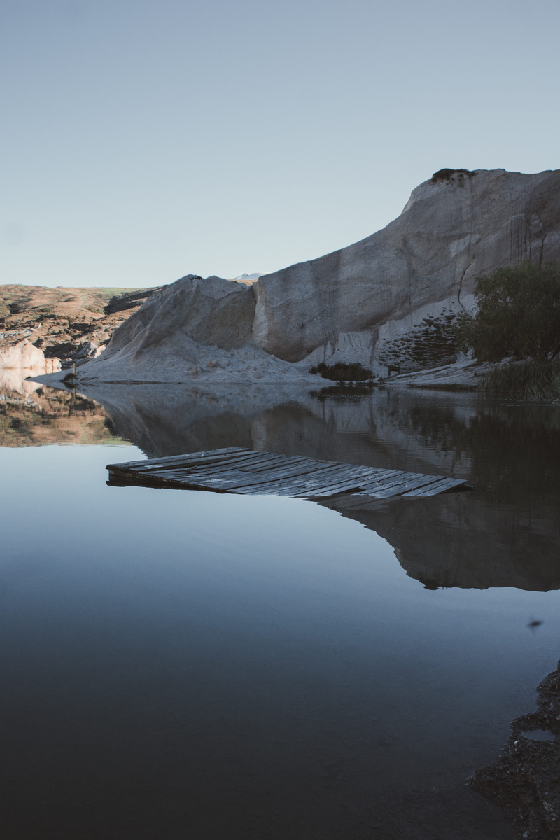 tranquility, docking, photography, non-urban scene, landscape, scenery, beauty in nature, idyllic, mountain, day, waterfront, pallet, shadow, rock, tree