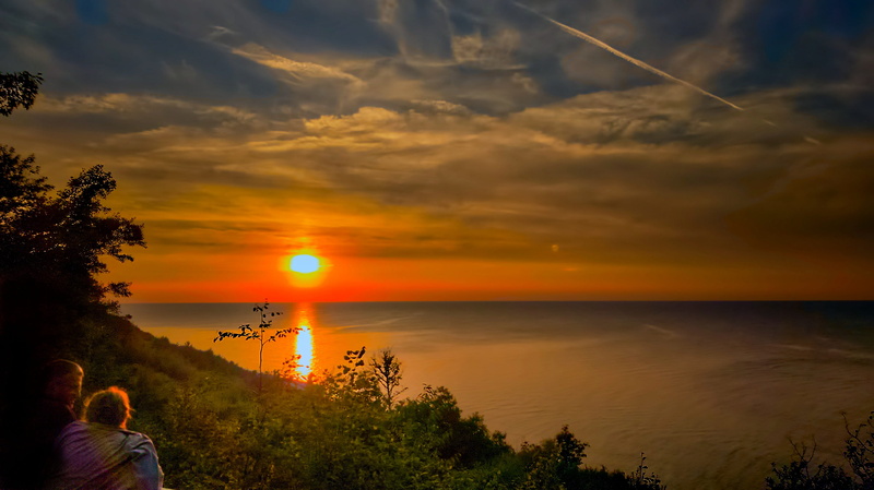 tranquility, leisure activity, looking at view, sun, nature, scenery, peace of mind, sunset, non-urban scene, real people, sea, tranquil scene, outdoors