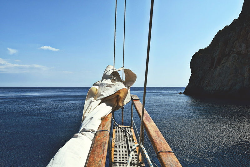 mode of transportation, near, boat, outdoors, nautical, ocean, sardinium, transportation, deck, water, sailboat, sail, yacht, sea, brown, rope, beauty in nature