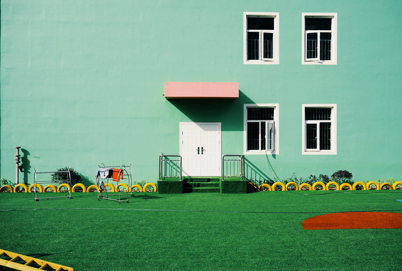 painted, sign, plant, residential district, building, building Exterior, wall - building feature, lawn, built Structure, colour, white, facade, architecture