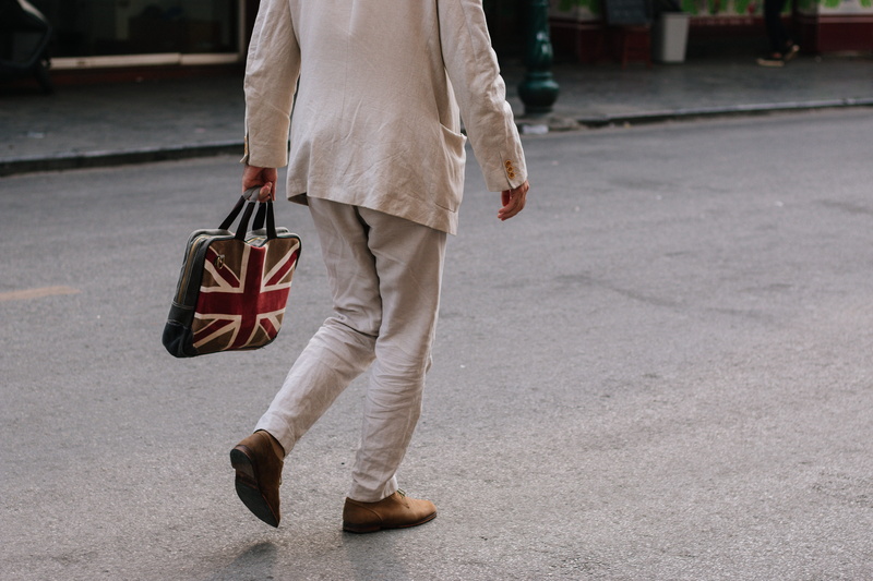 one person, male, street, gray, plastic bag, handbag, road, city, leisure activity, real people, men, lifestyles, social issues, holding, man, walking