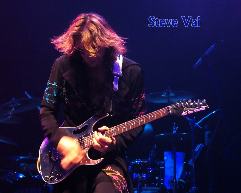 steve vai, long hair, popular music concert, real people, arts culture and entertainment, hair, musical instrument, light, guitar, music, artist, hairstyle