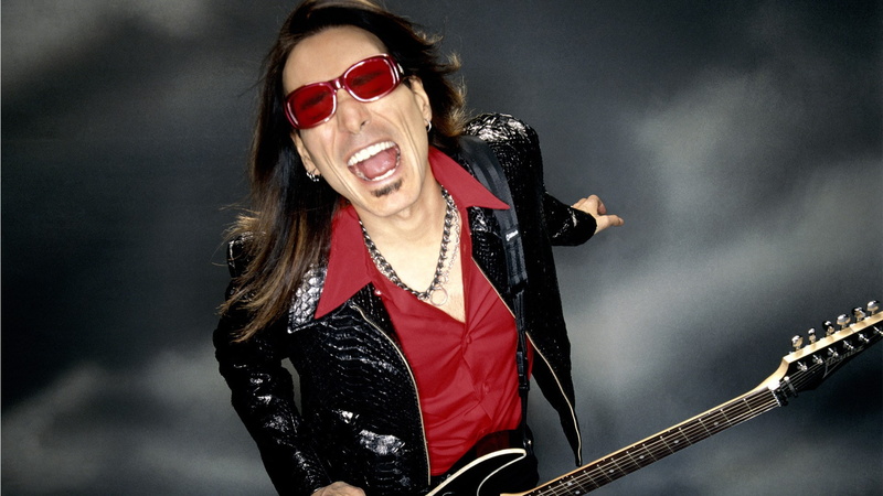 mouth open, glasses, indoors, one person, waist up, singing, hairstyle, jacket, music, portrait, long hair, arts culture and entertainment, sunglasses