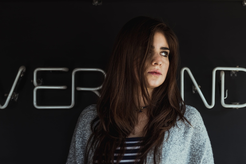 technology, cardigan, young women, front view, indoors, near, 4K, woman, beautiful woman, gray, one person, wall, neon, standing, black background, headshot