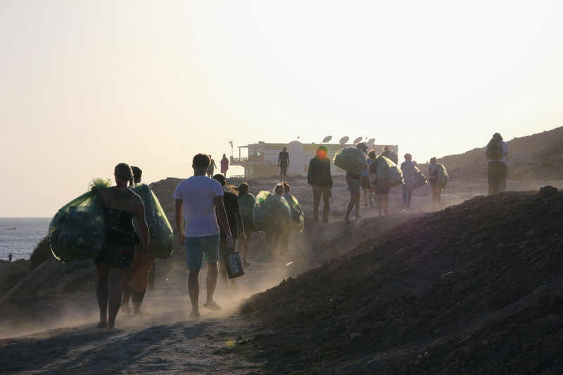 riding, crowd, transportation, garbage collection, domestic animals, beach, outdoors, waste disposal, garbage, adult, beachcleaning, sky, plastic waste