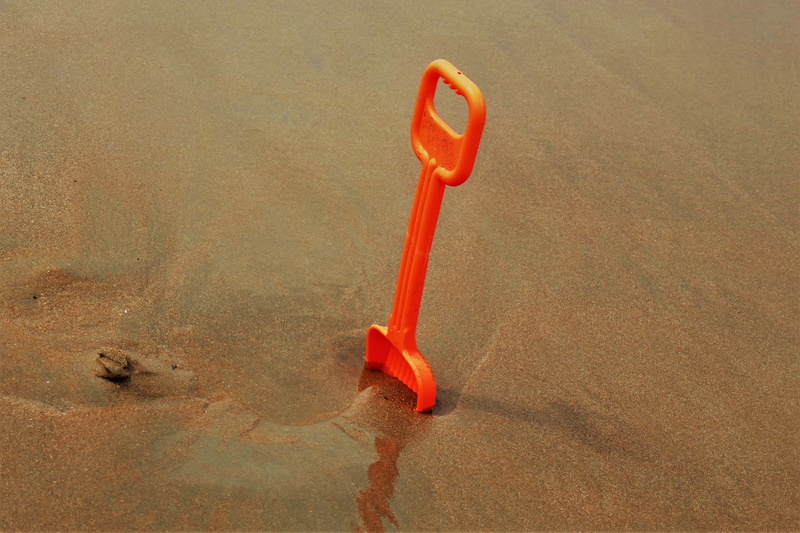 sea, plastic, play, water, high angle view, play outside, single object, landscape, sand, sand shovel, red, dirt, land, summer, toys, hand tool, day, outdoors