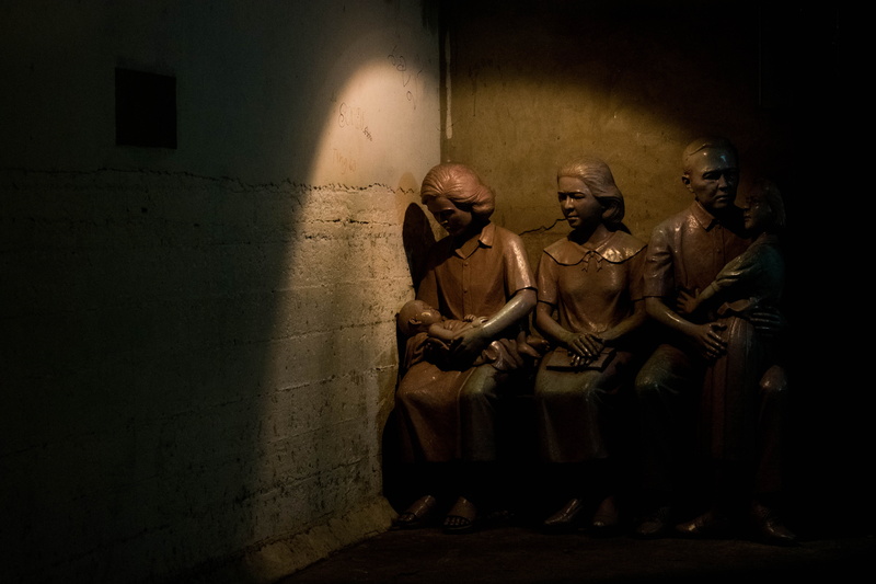 adult, family statue, group of people, air, air raid shelter, history, war, prisoner, aggression, mummy, indoors, emotion, military, clothing, statue, wall - building feature