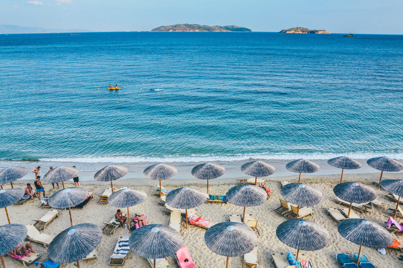 sea, tranquil scene, lounge, seashore, incidental people, parasols, island, umbrella, vacation, scenics - nature, water, tranquility, beauty in nature