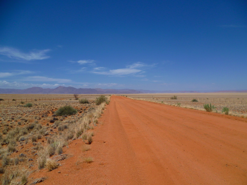 outdoors, endless, loneliness, tranquility, travel, horizon over land, climate, prairie, blue, no people, desert, landscape, road, non-urban scene, drought
