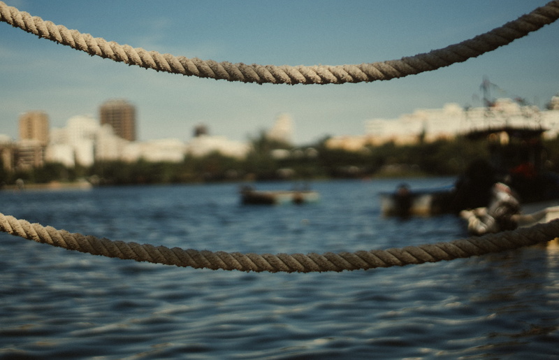nautical vessel, focus on foreground, brazil, day, nature, rope, bay, building exterior, lake, city, close-up, luxury, harbor, 5K, trees, architecture