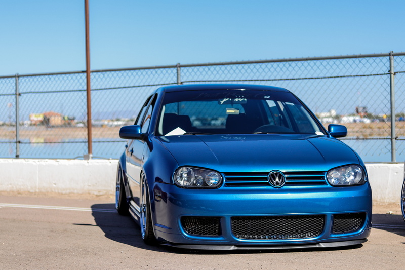 outdoors, automobile, fence, car wheel, barrier, race, spoke, sports car, blue, volkswagen, vintage car, boundary, city, vehicle, vw, nature, mode of transportation