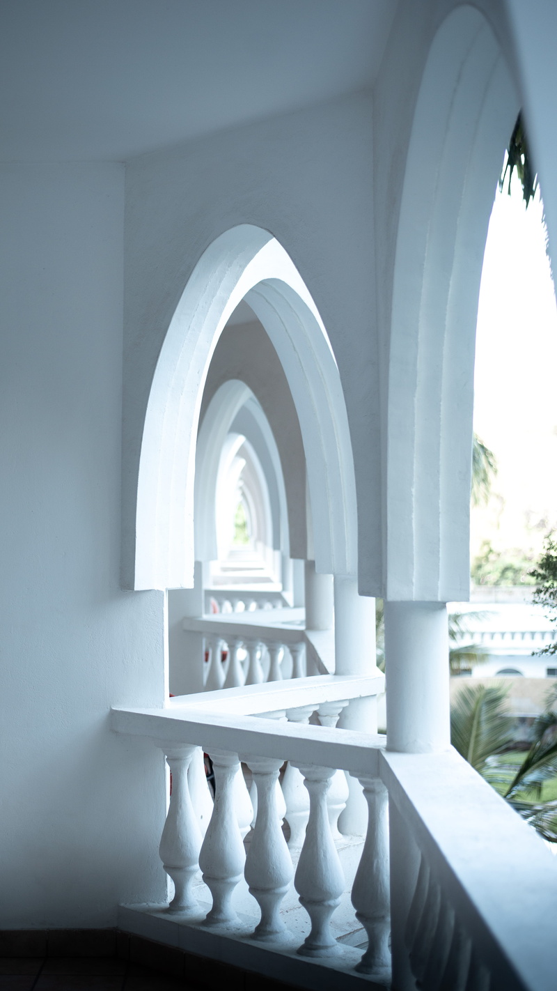 indoors, architectural column, handrail, banister, absence, day, corridor, floor, crypt, staircase, building, arcade, nature, balustrade, wall, white color