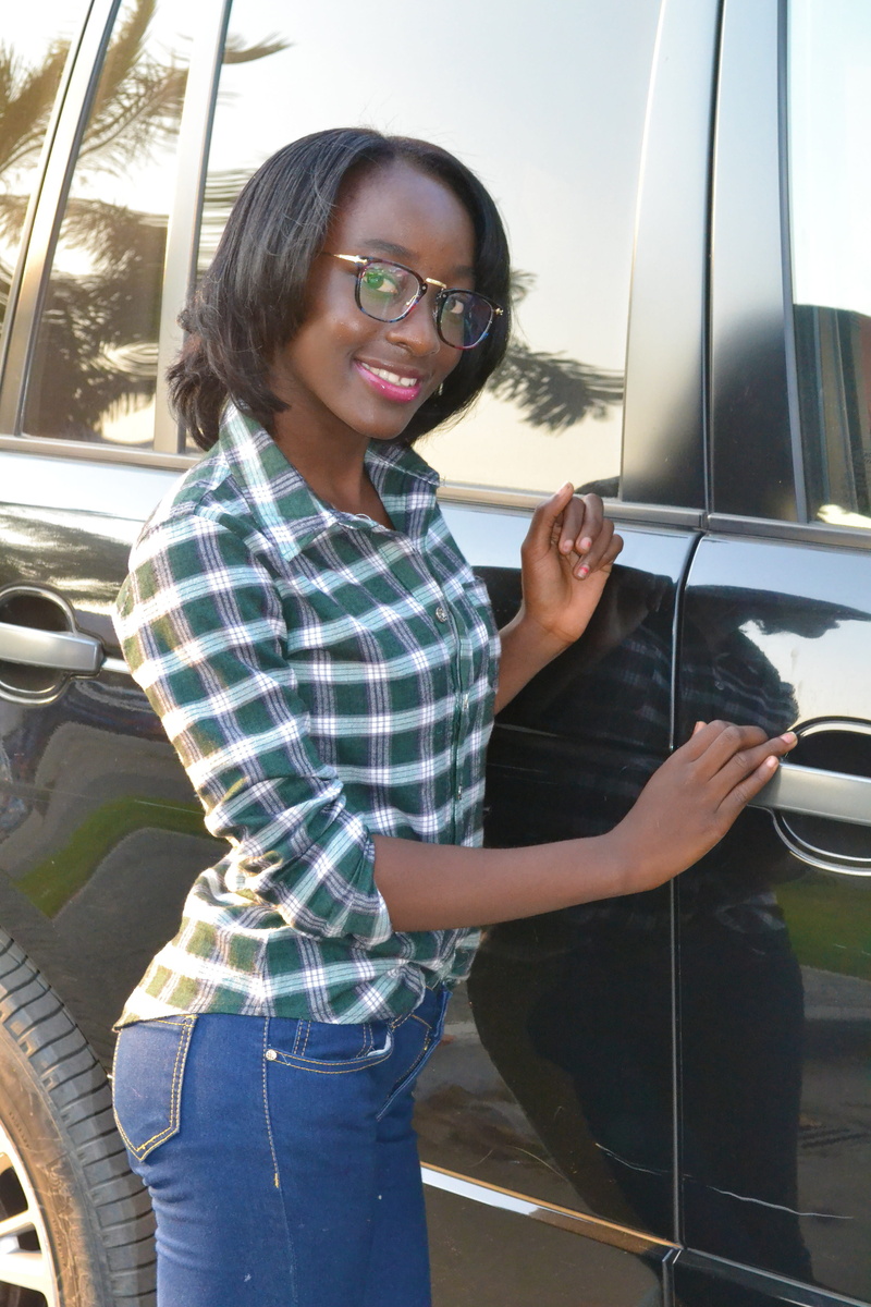 nair, three quarter length, smiley, girl, model, hairstyle, vehicle interior, lifestyles, satisfied, fashion, motor vehicle, looking at camera, angola