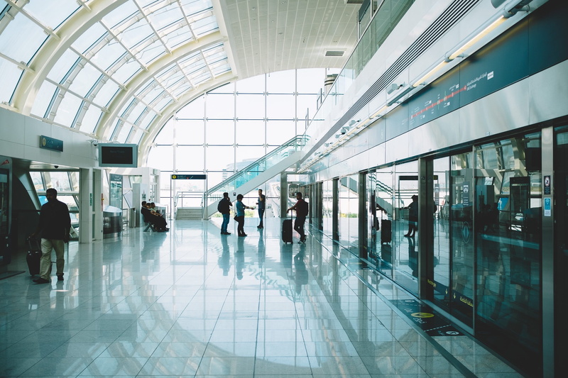 built structure, mode of transportation, waiting, indoors, real people, travel, transportation, leaving, walking, glass - material, sitting, passengers