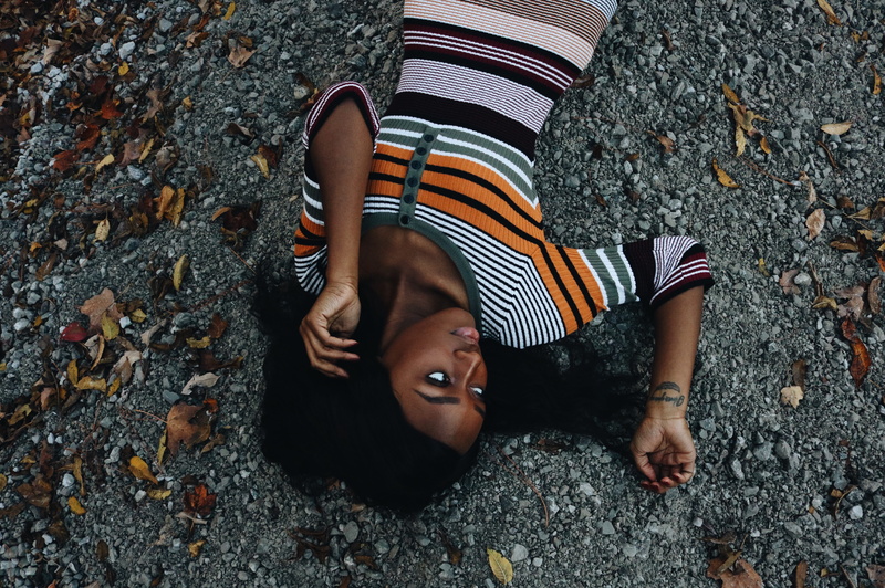 plant part, lying down, dried, nature, childhood, ground, lying, day, lifestyles, female, outdoors, high angle view, lying on back, child, looking at camera