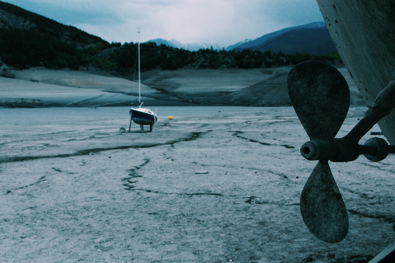 watercraft, empty, rider, trees, landscape, propeller, mountain range, dark, woods, broken, one person, cloud - sky, vehicle, land, transportation, rustic