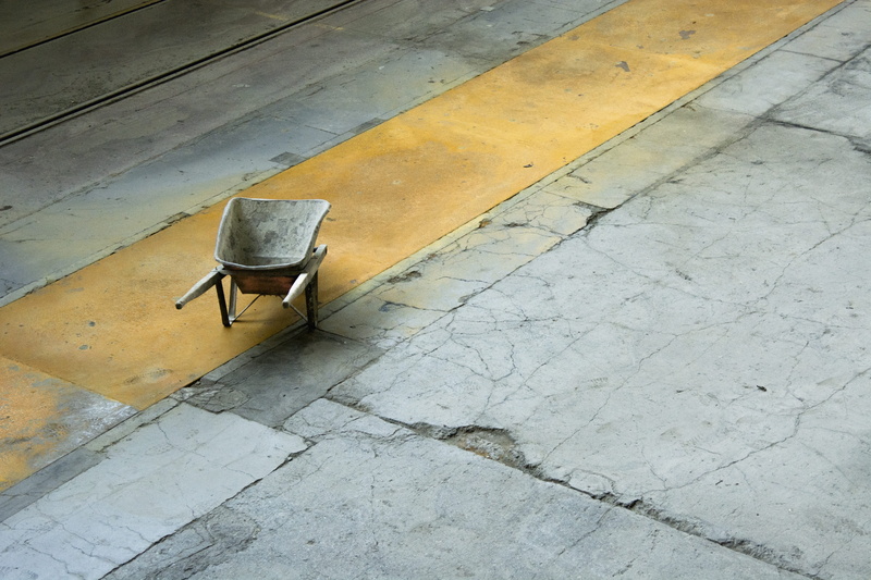 architecture, factory building, lapsed, wood - material, flooring, wheelbarrow, craft, still life, single object, sidewalk, outdoors, old, chair, ground
