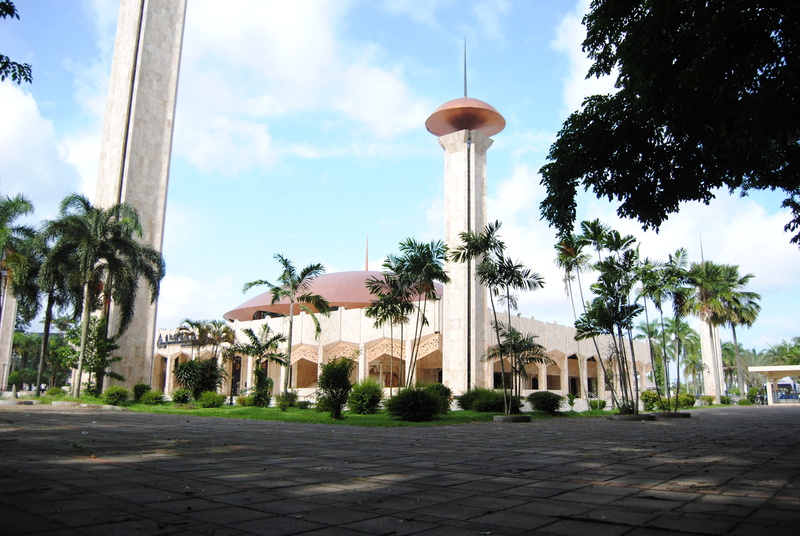 footpath, city, tropical climate, place of worship, building, cloud - sky, street, nature, building exterior, sunlight, mosque, architectural column, outdoors