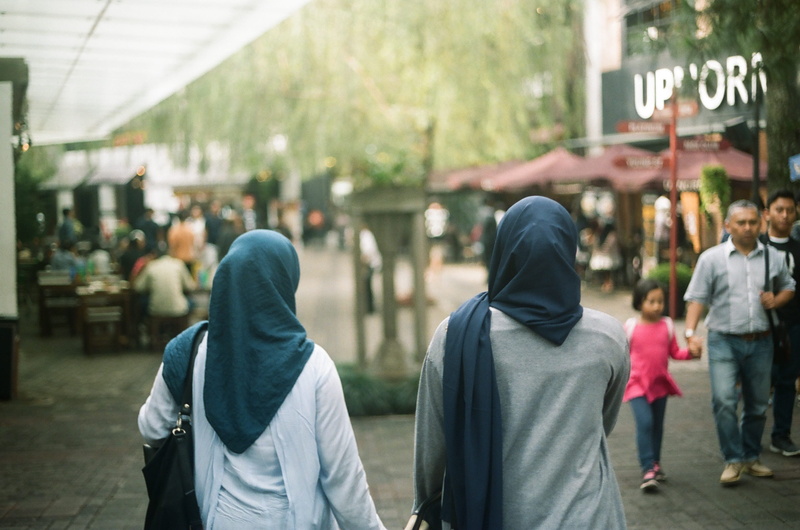 2K, crowd, incidental people, day, people, outdoors, men, architecture, interest, lifestyles, hood - clothing, motion, rear view, focus on foreground