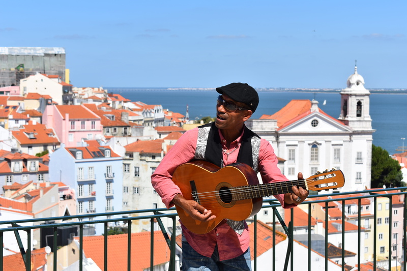 alfama, busker, built structure, real people, 5K, architecture, portugal, playing, leisure activity, building, guitar, sea, travel, city, lifestyles, lisbon