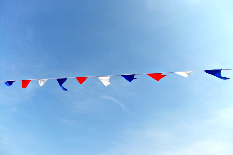 string, sunshine, wind, bunting, celebration, low angle view, shape, triangle shape, day, white, colours, no people, multi colored, nature, red, cloud - sky