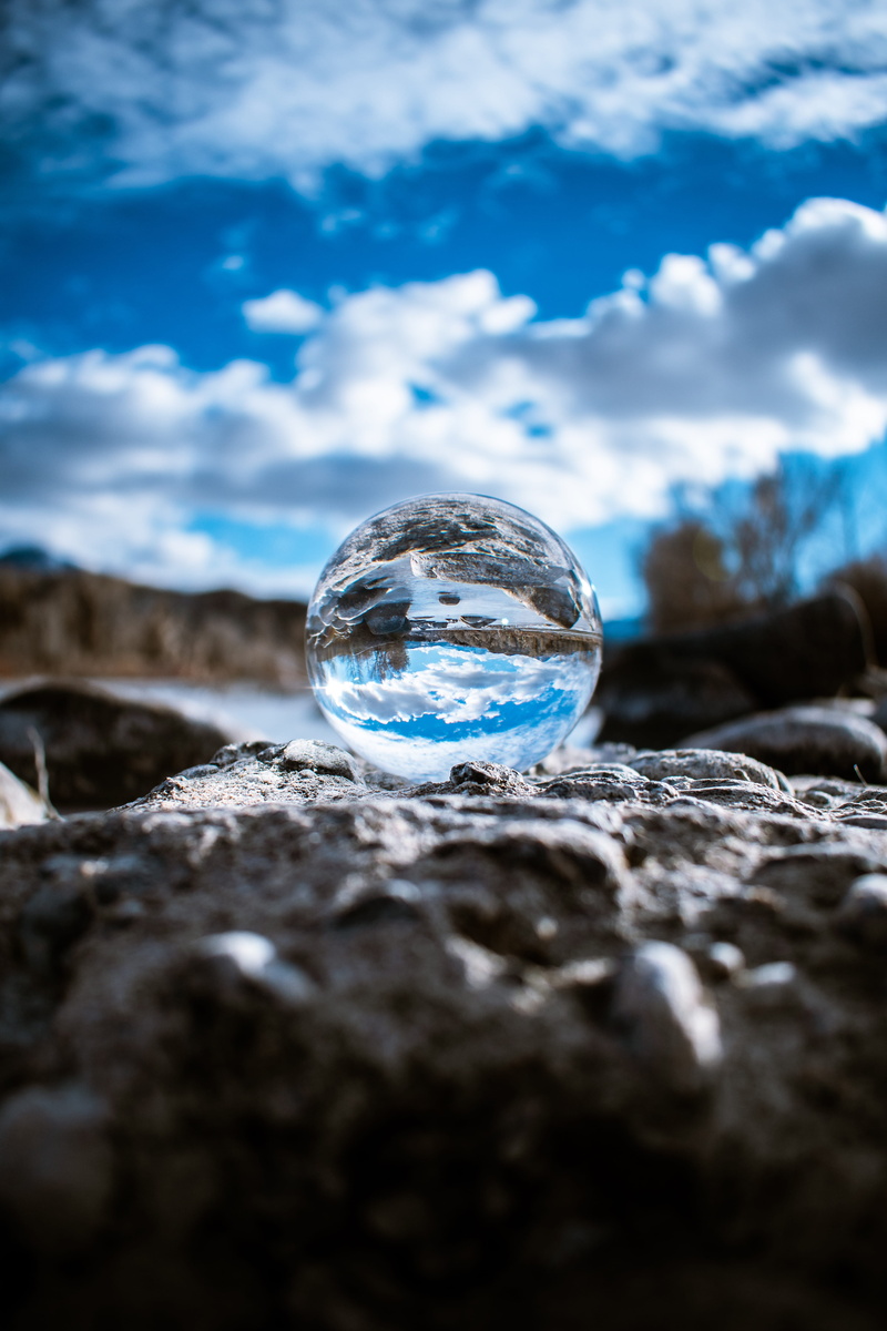sphere, clouds, glass, daylight, cloud, scenic, no people, stone, crystal ball, transparent, lens, land, single object, blue sky, cloud - sky, nature, blue