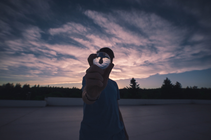 holding, hedge, waist up, adult, silhouette, teenager, child, tree, lensball, pose, tranquil scene, leisure activity, ball, man on roof, cloud - sky, concrete