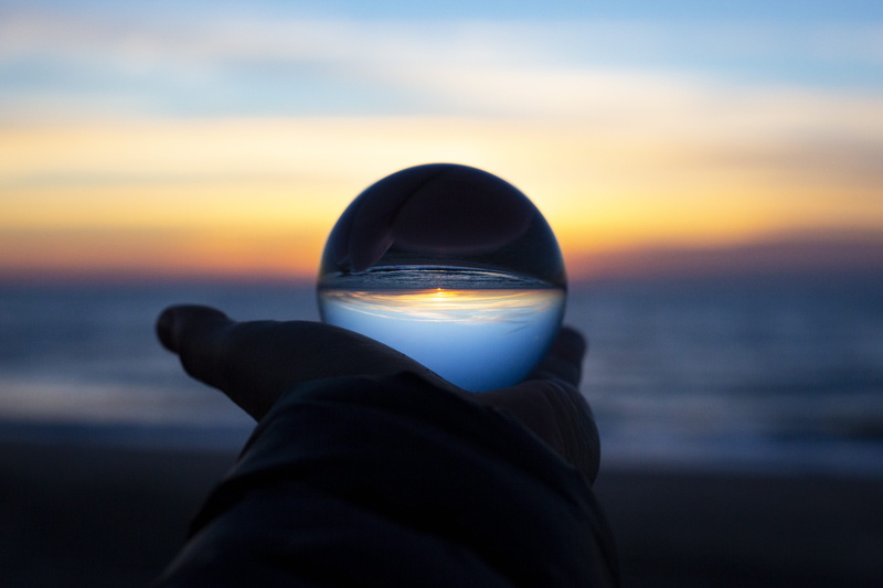 beach, cloud - sky, sphere, focus on foreground, sc, outdoors, clothing, unrecognizable person, glass, 5K, observatory, hood, clear, sea, human limb, dusk