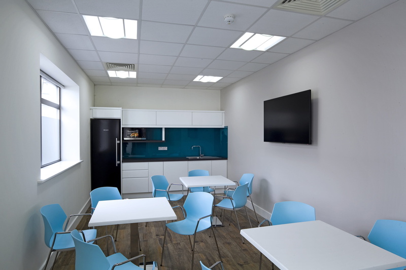 domestic room, office, modern, wall - building feature, indoors, blue, table, empty, flooring, seat, architecture, business, canteen, television set, ceiling