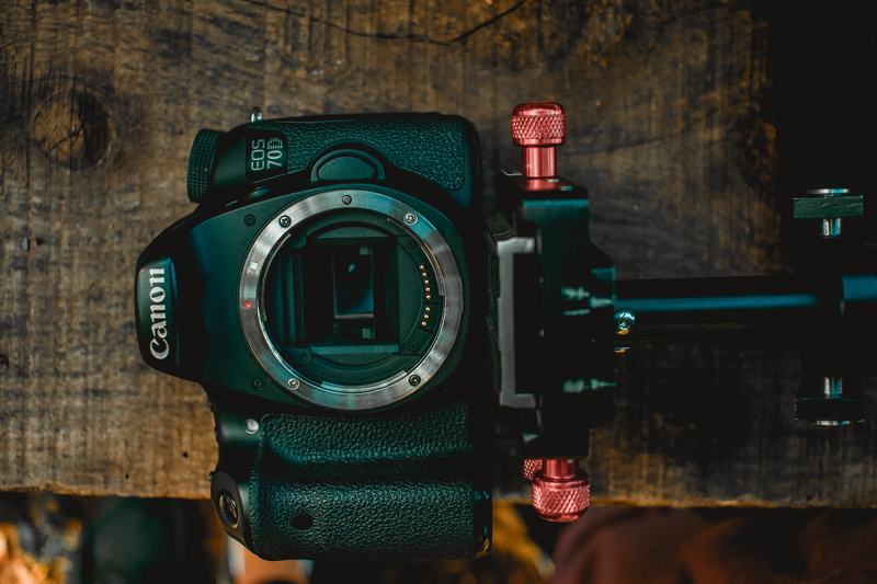 table, digital camera, western script, black, setup, dslr, focus on foreground, technology, number, indoors, no people, eos, tripod, camera, still life