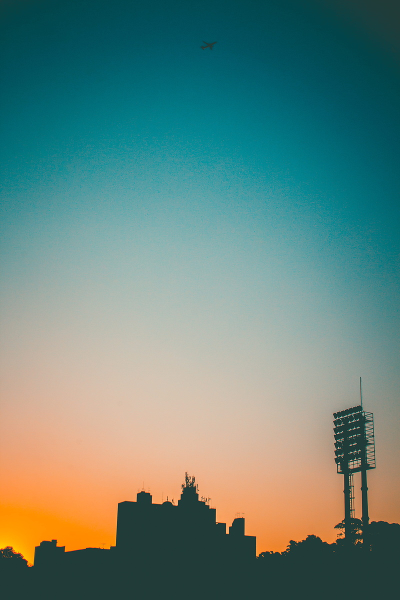 building exterior, low angle view, brazil, airplane, skyscraper, brasil, estádio primeiro de maio, sbc, landscape, sundown, outdoors, yellow, são bernardo do campo