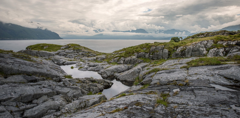 outdoors, body, clouds, grass, blue, no people, near, beauty in nature, 4K, scenics - nature, green, land, rocky, landscape, mountain, environment, sea