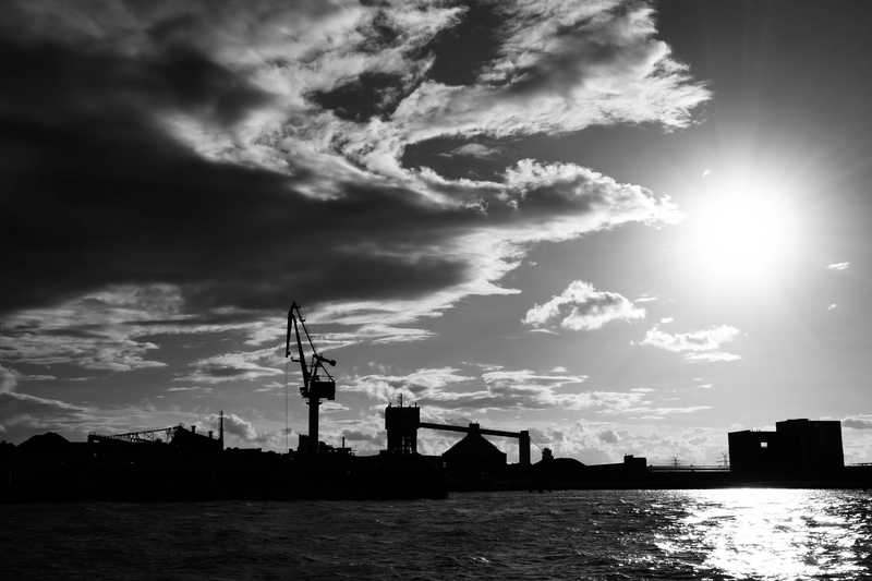 evening sky, building, construction equipment, sunlight, building exterior, sea, outdoors, crane - construction machinery, clouds, architecture, cloud - sky