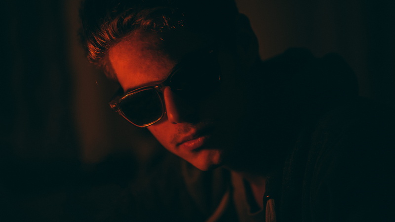 focus on foreground, glasses, lifestyles, color, portrait, real people, adolescence, shadow, adult, contemplation, sunglasses, teenager, intense, red, 5K